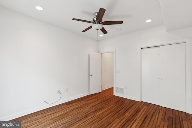 unfurnished bedroom featuring a closet, ceiling fan, and dark hardwood / wood-style flooring