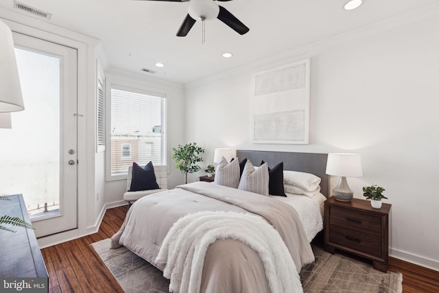 bedroom featuring ceiling fan, dark hardwood / wood-style floors, and crown molding