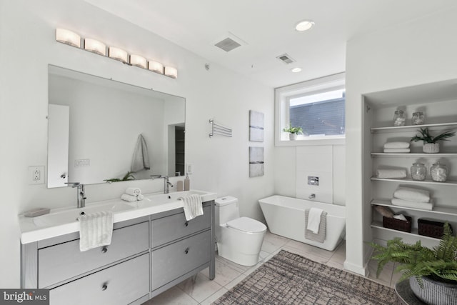 bathroom featuring tile patterned floors, a washtub, and vanity