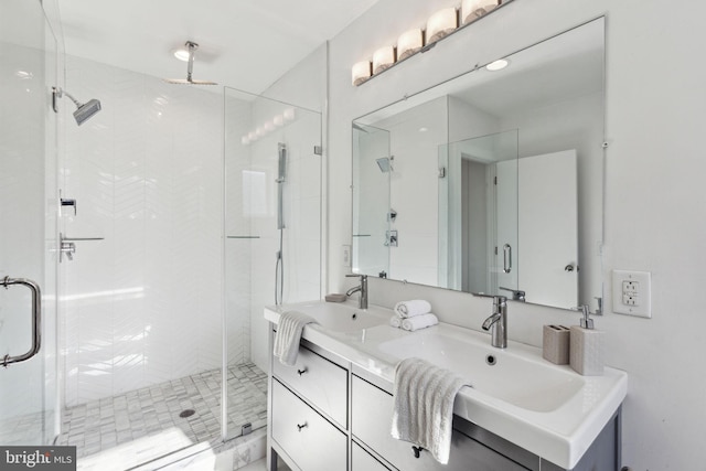 bathroom featuring ceiling fan, vanity, and a shower with shower door