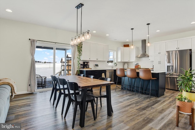 dining area with recessed lighting, baseboards, and wood finished floors