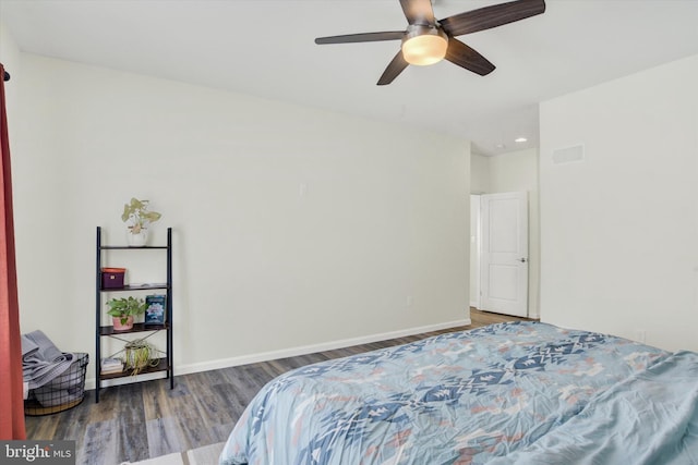 bedroom with visible vents, ceiling fan, baseboards, and wood finished floors