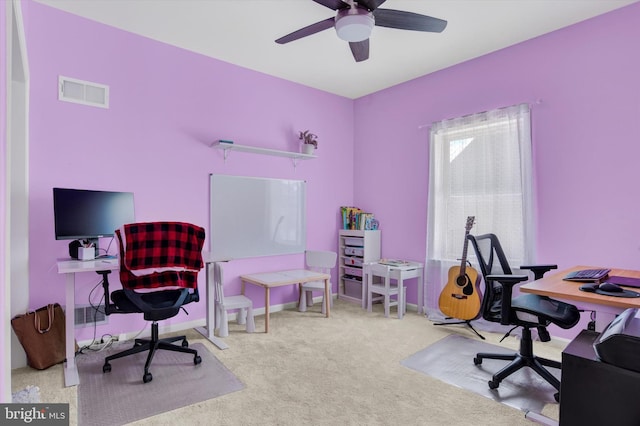 carpeted office featuring visible vents, baseboards, and a ceiling fan