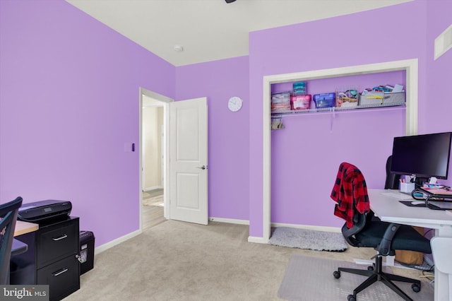 home office with light carpet and baseboards