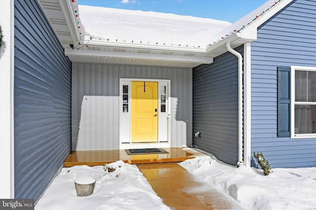 view of snow covered property entrance