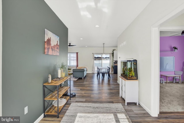 corridor with recessed lighting, baseboards, and wood finished floors