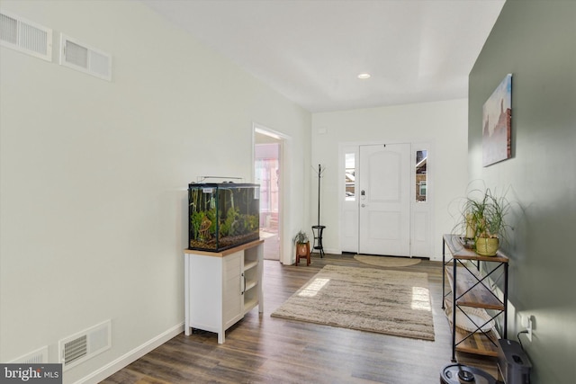 entrance foyer featuring visible vents, recessed lighting, dark wood-type flooring, and baseboards