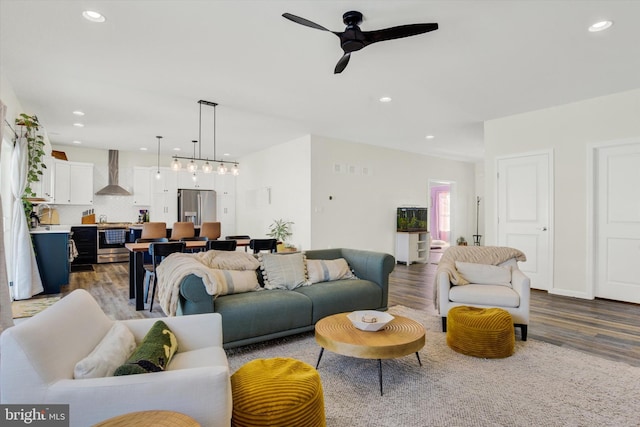 living room with a ceiling fan, recessed lighting, and dark wood-style floors