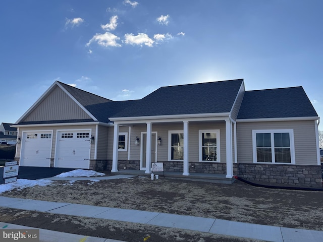 view of front facade featuring a garage and covered porch