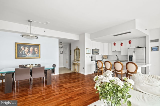 living room featuring dark hardwood / wood-style flooring and sink