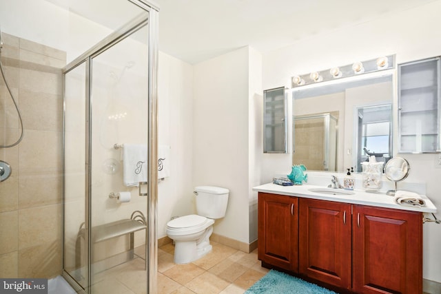 bathroom featuring tile patterned flooring, vanity, toilet, and walk in shower