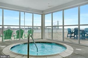 view of swimming pool featuring an indoor hot tub