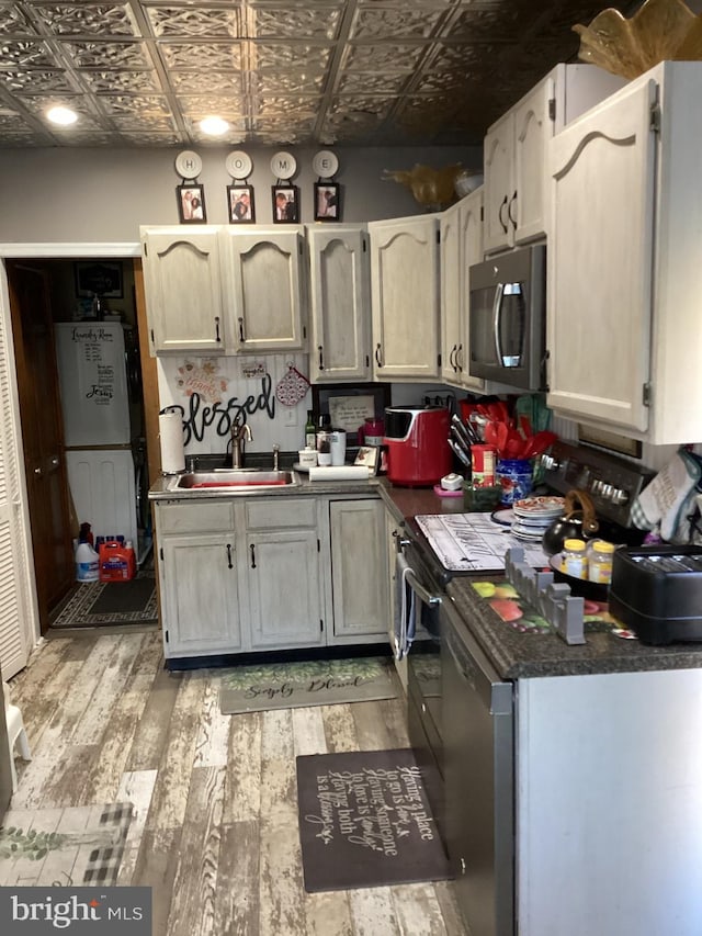 kitchen featuring light wood-type flooring and sink