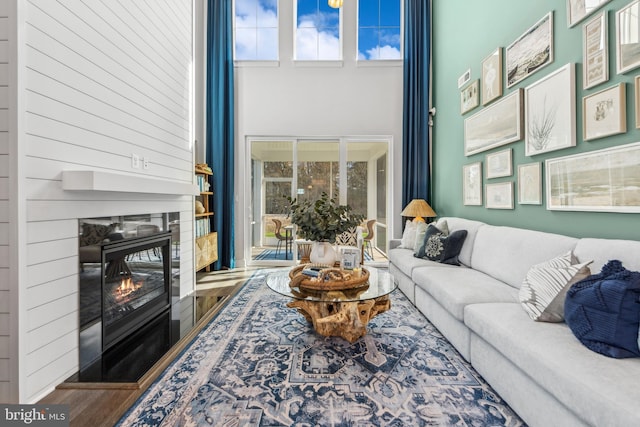 living room with a high ceiling and hardwood / wood-style floors