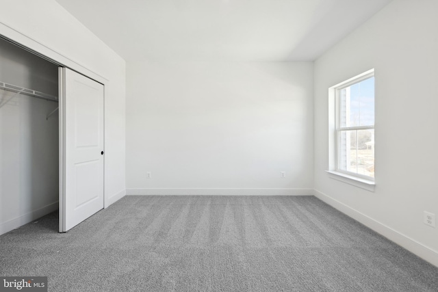 unfurnished bedroom with carpet flooring and a closet