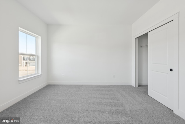 unfurnished bedroom with carpet and a closet