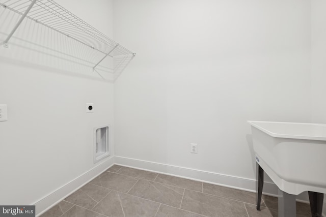 laundry room featuring sink, tile patterned flooring, and electric dryer hookup