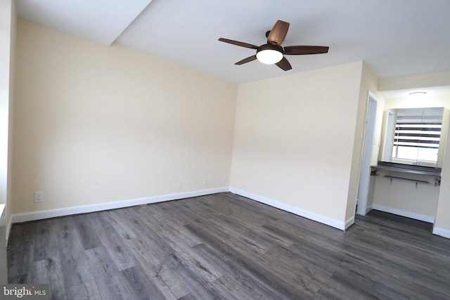 unfurnished room featuring ceiling fan and dark wood-type flooring