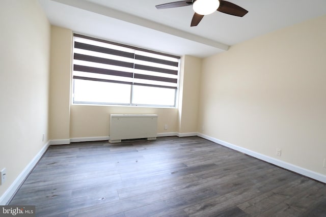 unfurnished room featuring ceiling fan, dark hardwood / wood-style flooring, and radiator