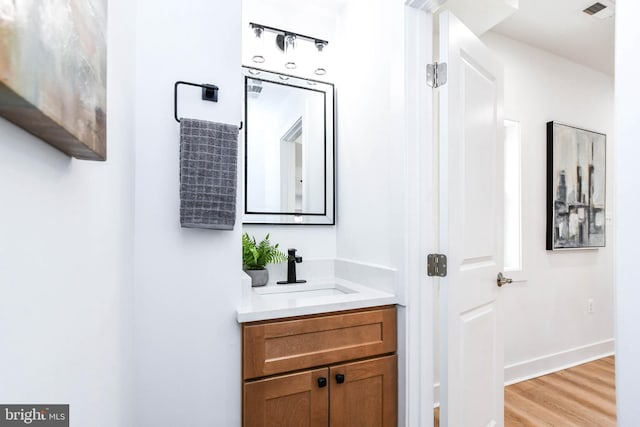 bathroom featuring hardwood / wood-style flooring and vanity