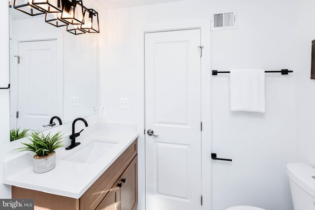 bathroom featuring toilet and vanity