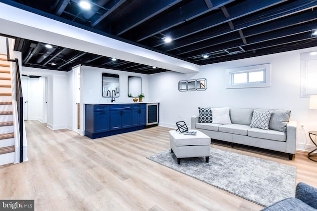 living room featuring beverage cooler and light hardwood / wood-style floors