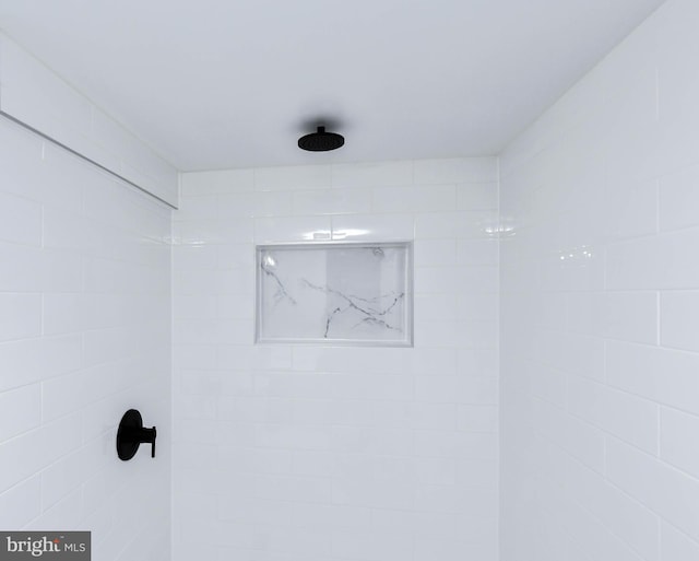 bathroom with tiled shower