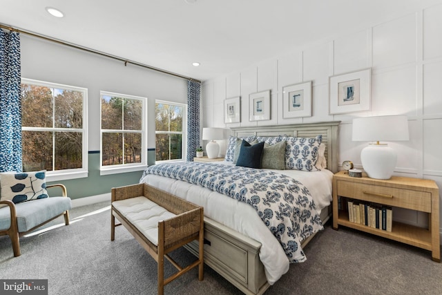 bedroom with dark colored carpet