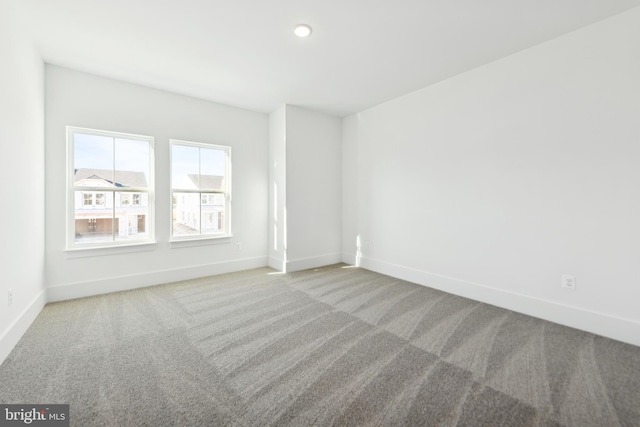 unfurnished room featuring light carpet