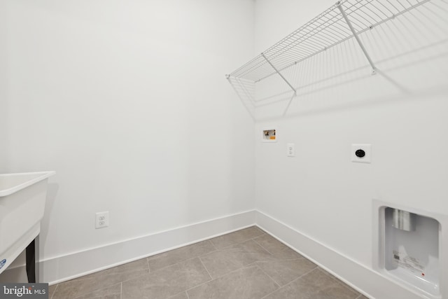 laundry room with hookup for a washing machine, electric dryer hookup, and tile patterned floors