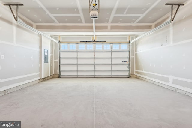 garage featuring a garage door opener and electric panel