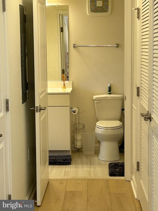 bathroom featuring toilet, tile patterned floors, and vanity