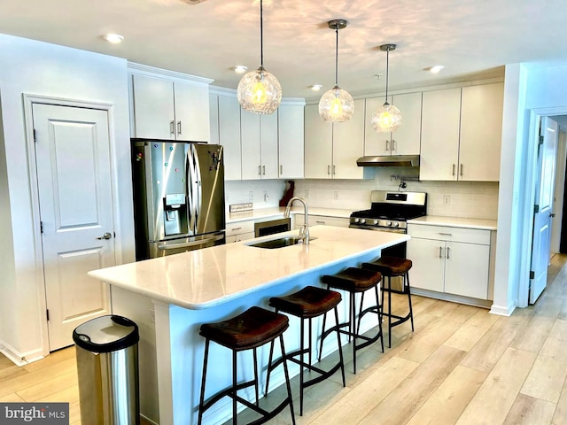 kitchen with stainless steel appliances, white cabinets, pendant lighting, and sink