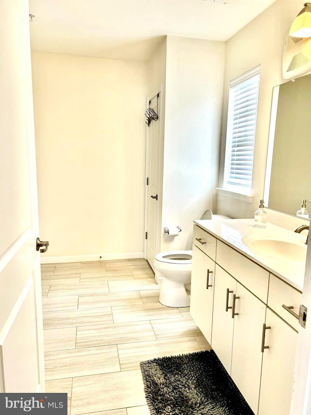 bathroom featuring toilet and vanity