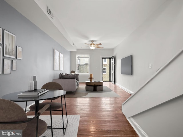 living room with hardwood / wood-style flooring and ceiling fan