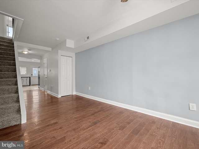 empty room with hardwood / wood-style flooring