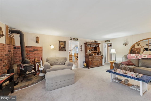 carpeted living room featuring a wood stove