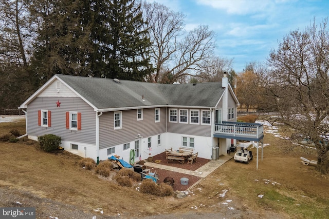 rear view of property featuring a deck and a yard