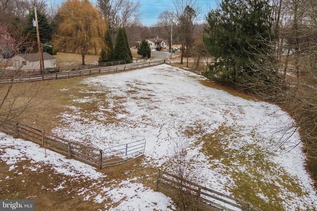 yard layered in snow with a rural view