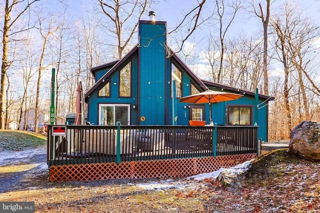 snow covered property with a deck