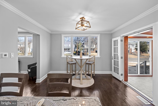 dining room featuring a healthy amount of sunlight and crown molding