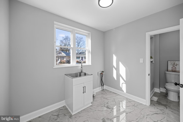 clothes washing area featuring washer hookup and sink