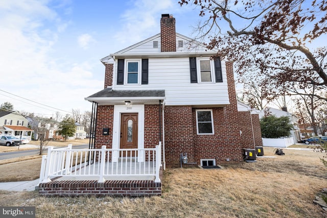 view of front property with cooling unit and a front yard