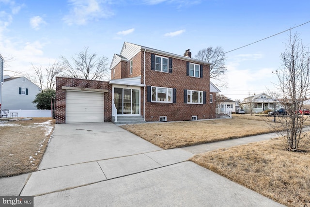 view of front of property with a garage and a front lawn