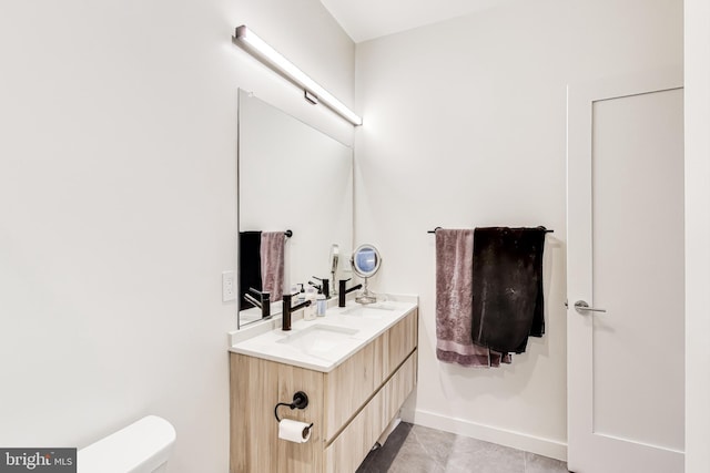 bathroom featuring toilet, tile patterned flooring, and vanity