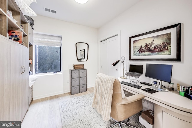 office space with light wood-type flooring