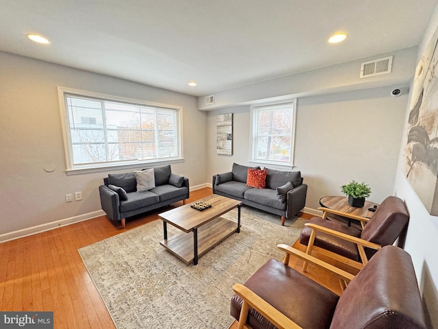 living room with hardwood / wood-style floors and a healthy amount of sunlight