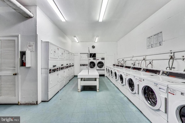 clothes washing area featuring washer and dryer and stacked washer and dryer