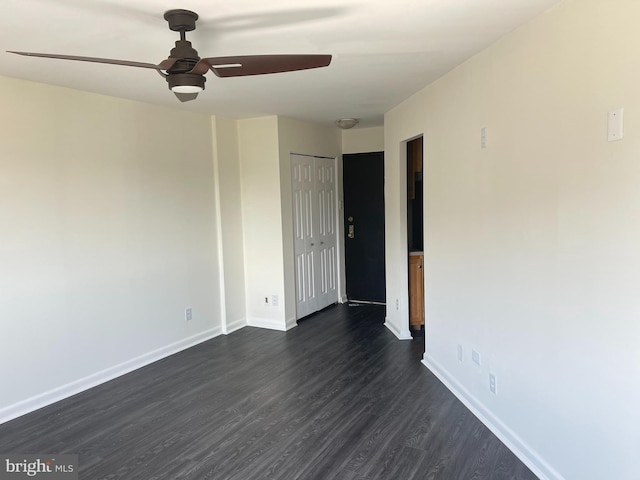 unfurnished room with ceiling fan and dark hardwood / wood-style flooring