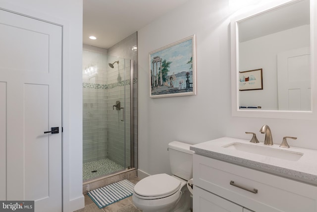 bathroom featuring toilet, walk in shower, and vanity